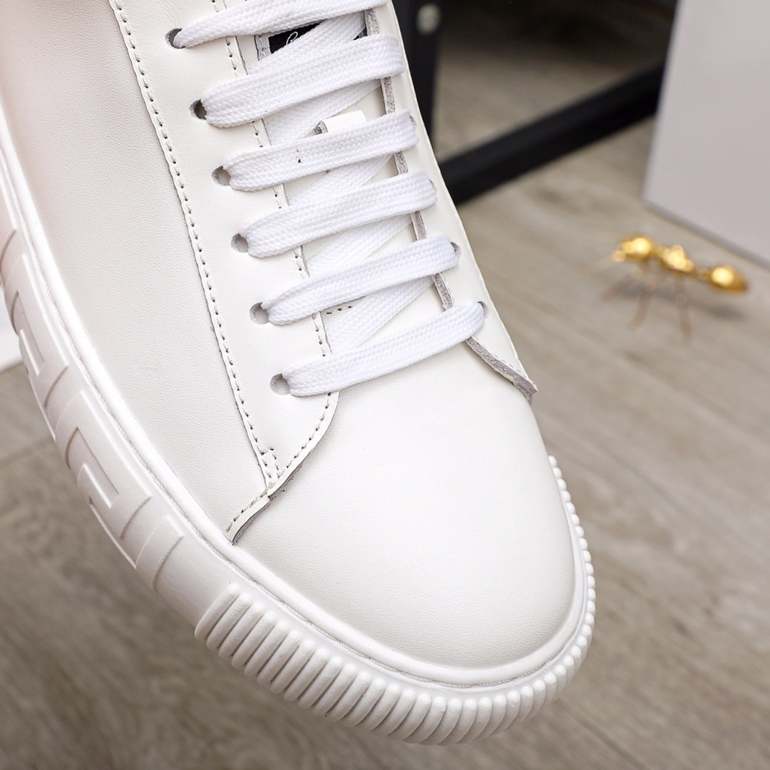 White Versace sneaker close-up with lace panel, stitching, and textured platform outsole