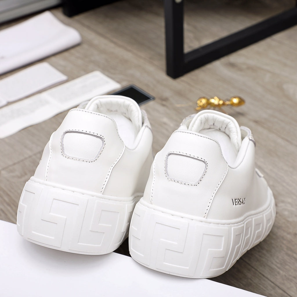 Versace white sneakers rear view showing heel logo patch and chunky textured platform sole