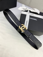 Chanel belt with dark strap, embossed pattern, and gold-tone circular buckle