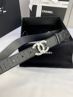 Chanel belt detail: dark embossed strap with round gold-tone CHANEL buckle