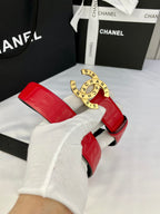 Red Chanel belt and gold circular CHANEL medallion buckle, strap folded over