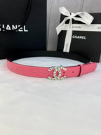 Pink Chanel belt with gold circular logo buckle and adjustable holes