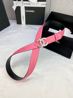 Pink Chanel belt with gold circular Chanel logo buckle and curved strap