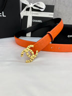 Chanel belt with orange embossed strap and gold-tone round logo buckle