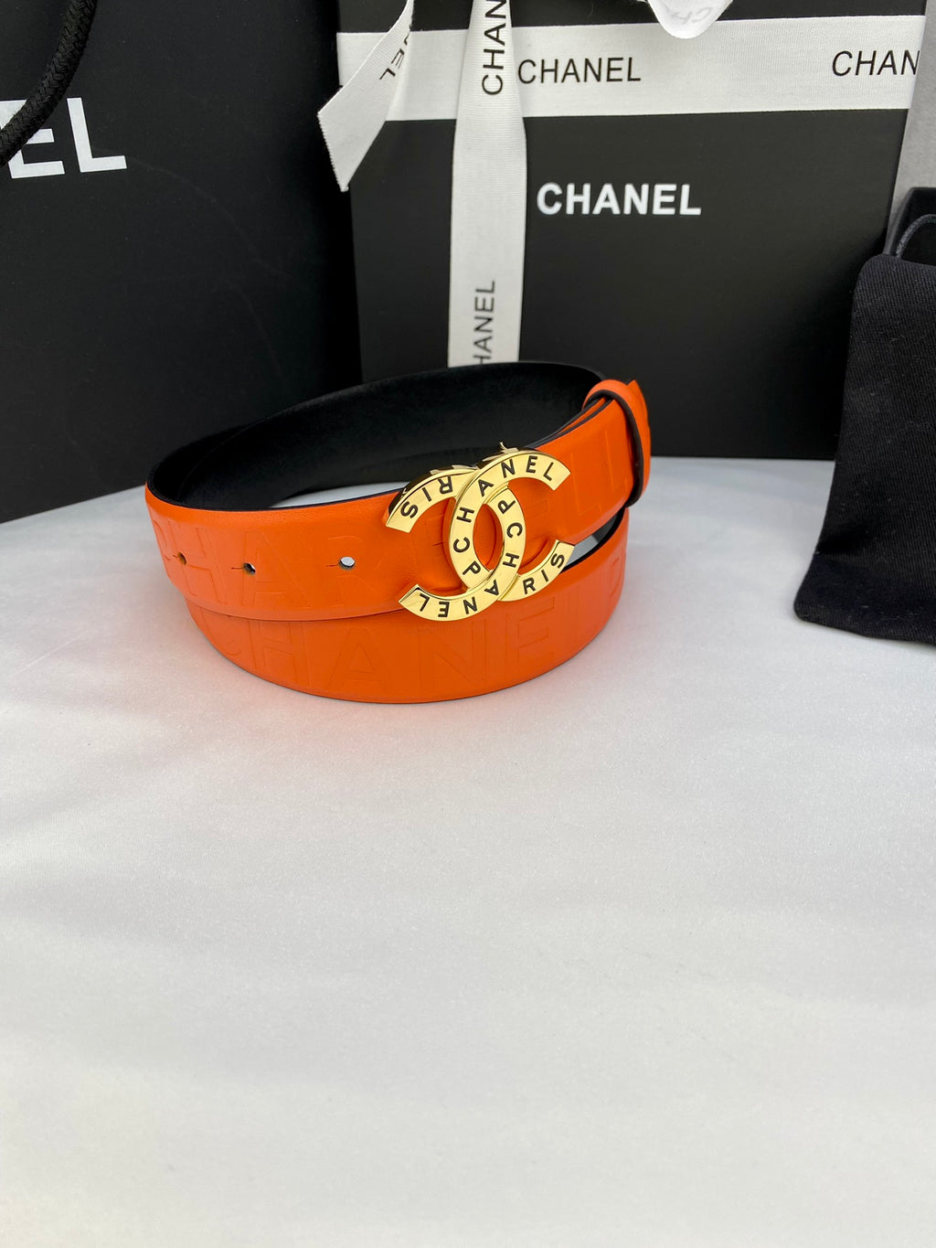 Chanel belt with orange wide strap and gold-tone round logo buckle