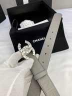 Beige Chanel belt with circular logo buckle and adjustable holes on strap