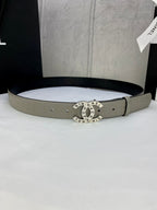 Beige Chanel belt with perforated buckle and circular logo medallion center