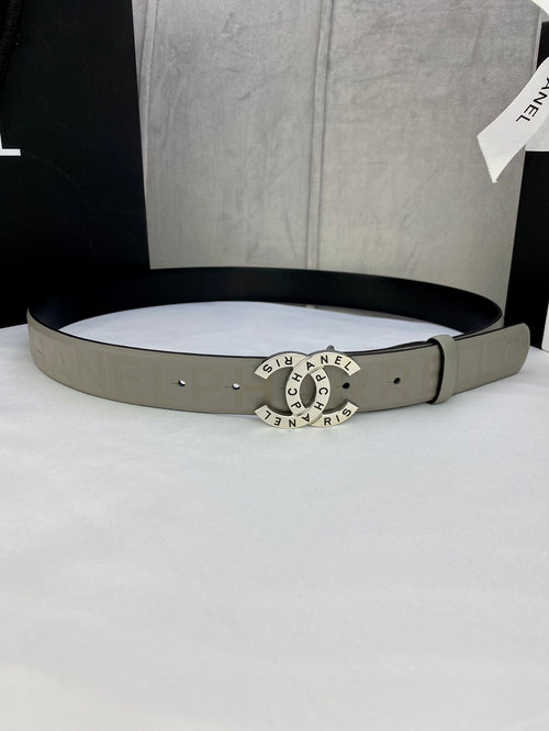 Beige Chanel belt with perforated buckle and circular logo medallion center