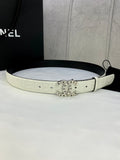 White Chanel belt with circular gold logo buckle, strap holes and embossed lettering