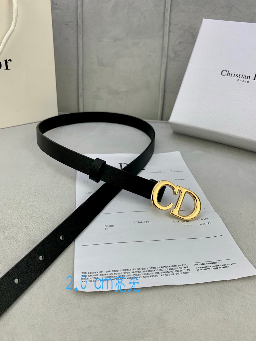 Black leather belt with gold-tone CD buckle