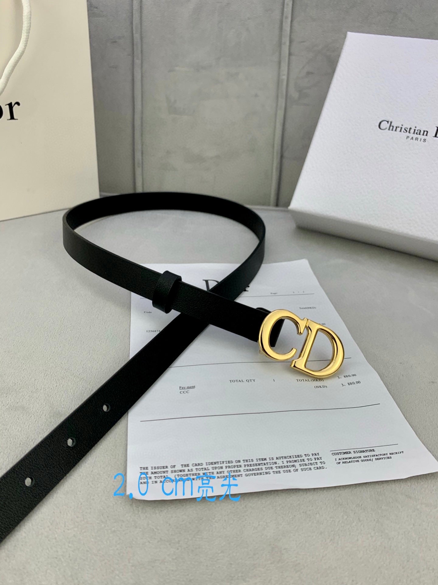 Black leather belt with gold-tone CD buckle