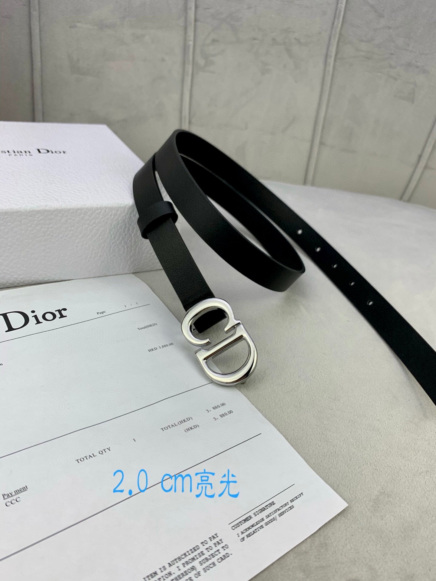 Black leather belt with silver-tone CD buckle