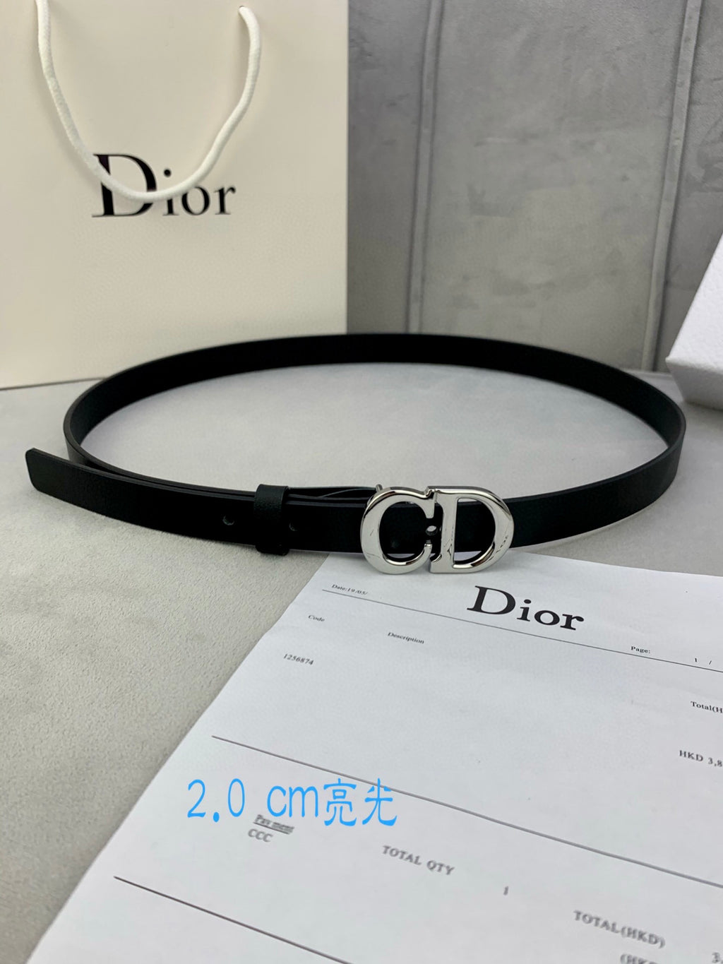 Black leather belt with silver-tone CD buckle