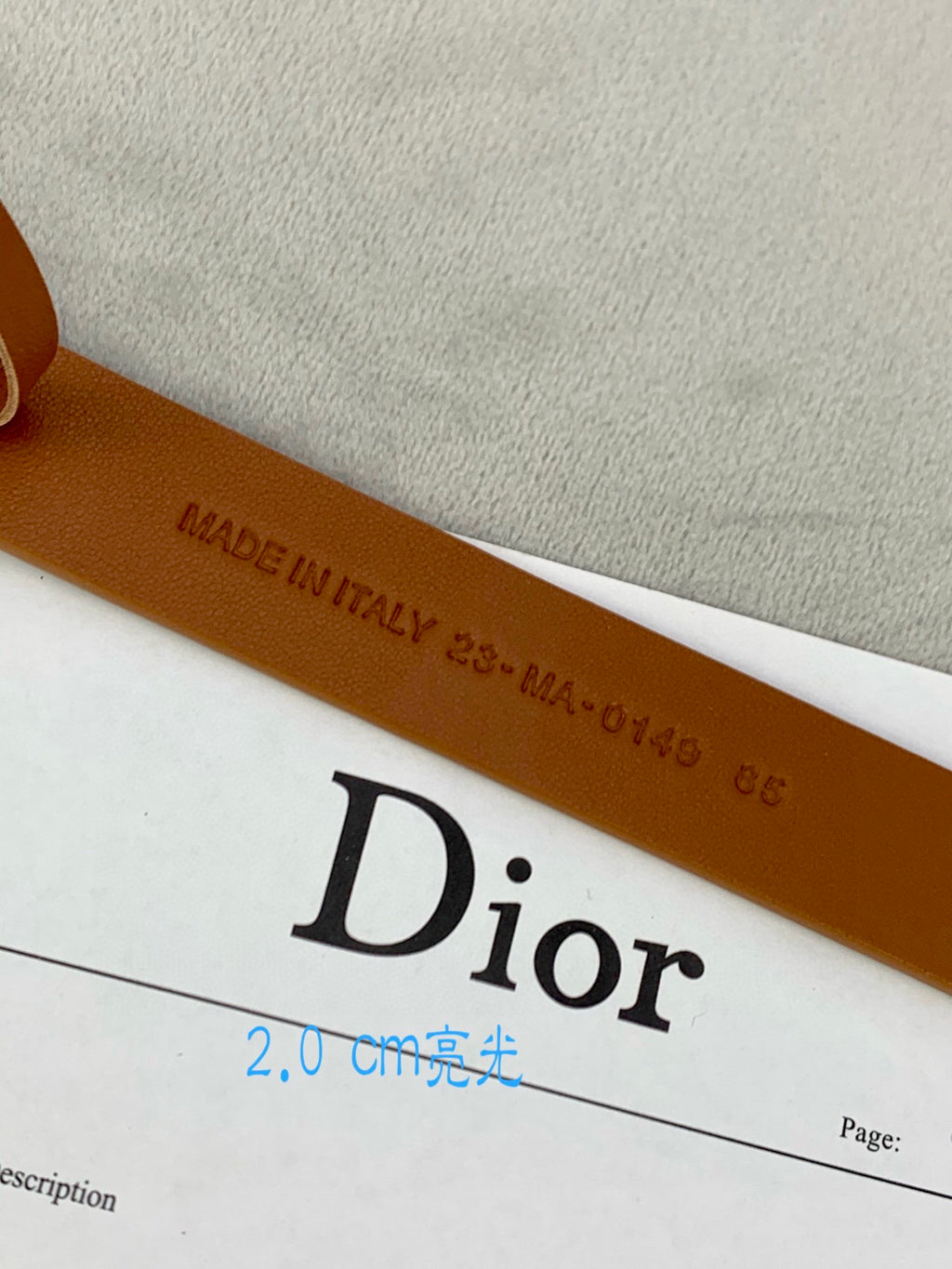 Tan belt strap with Made in Italy stamp and Dior logo print