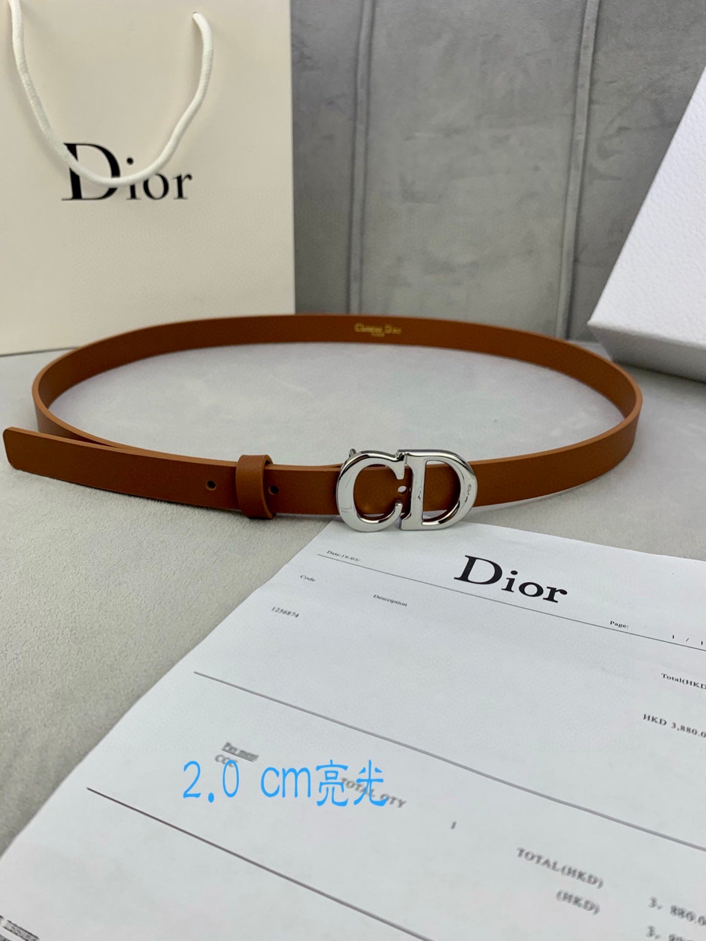 Tan leather belt with CD buckle and adjustable holes