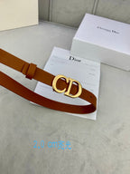 Tan leather belt with gold-tone CD buckle on a Dior card