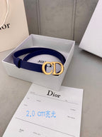 Blue Dior belt with CD logo buckle, resting in a branded box.