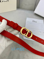 Dior red belt with CD buckle worn on a white glove hand