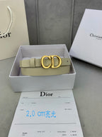 Beige leather belt with gold-tone CD buckle resting in a gift box