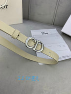 Beige belt with silver-tone CD buckle and adjustable holes