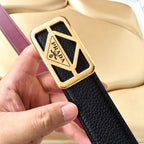 Prada belt buckle close-up on black leather strap with burgundy edge