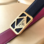 Prada belt detail: gold-tone logo buckle on dark blue strap with burgundy edge