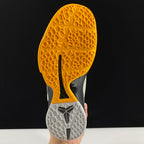 Nike basketball shoe outsole with yellow traction tread and gray textured forefoot