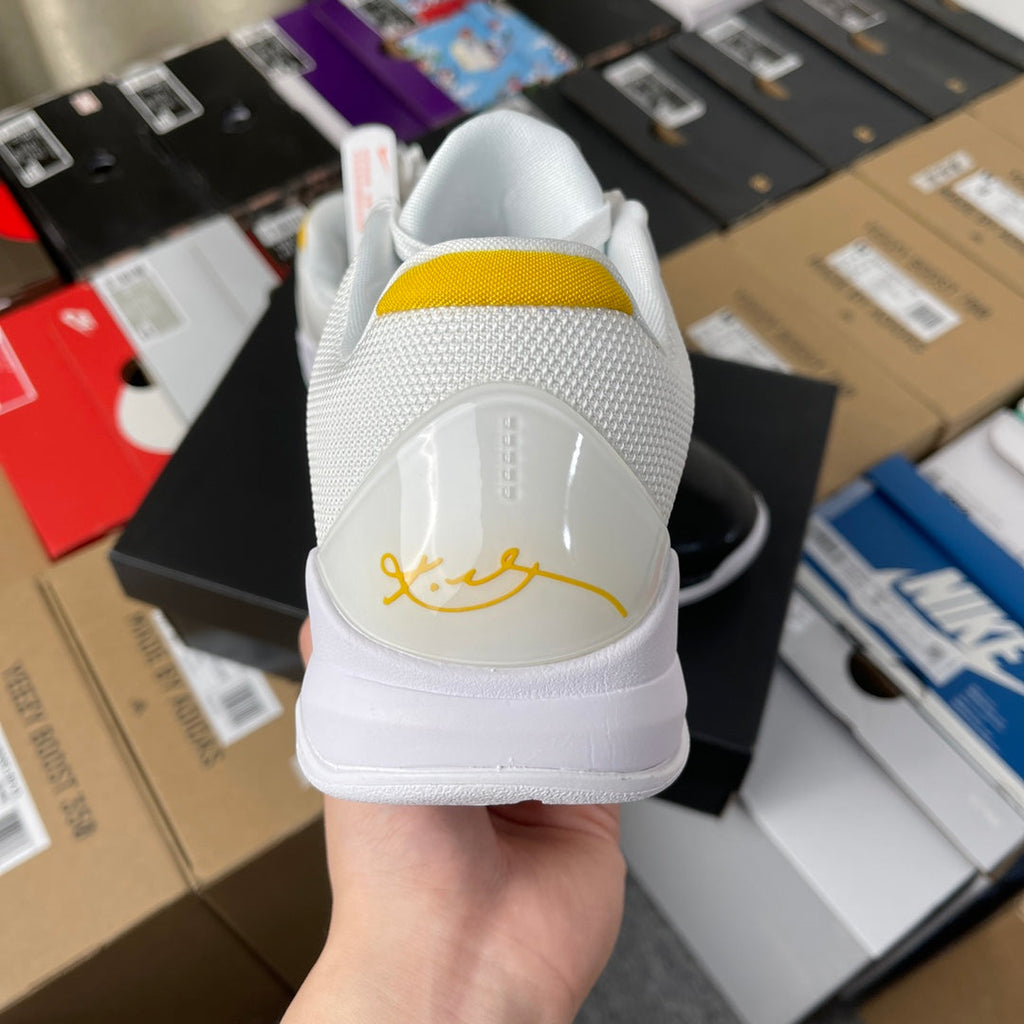 Nike Zoom Kobe 5 Protro basketball shoe, back view with white heel tab and yellow accent