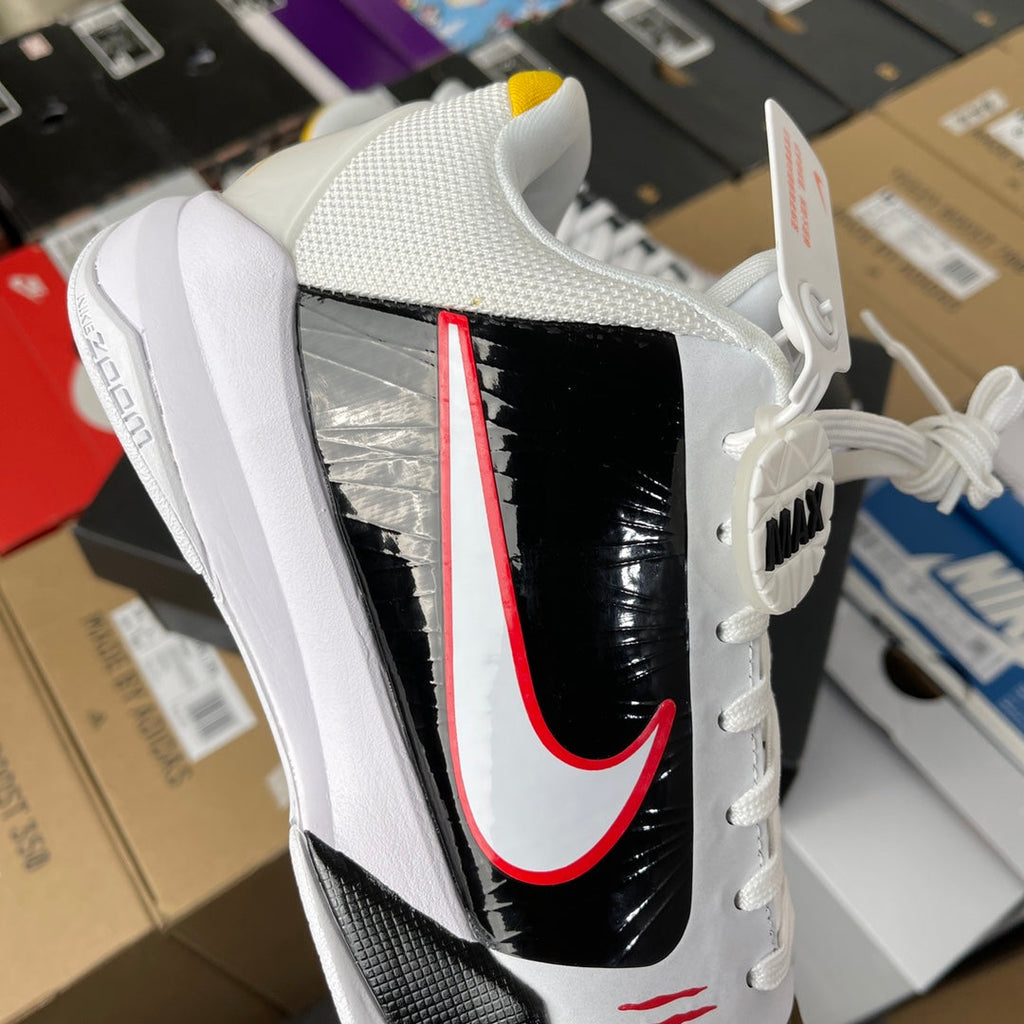 Nike Zoom Kobe 5 Protro basketball shoe, angled view with black glossy panel and red swoosh
