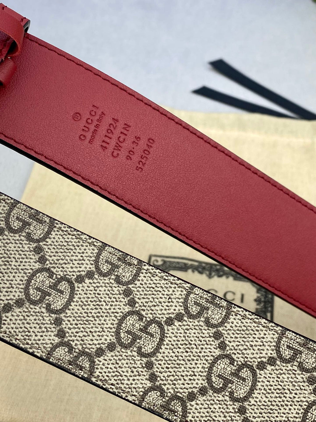 Gucci belt close-up of red leather strap with embossed Gucci text and numbers