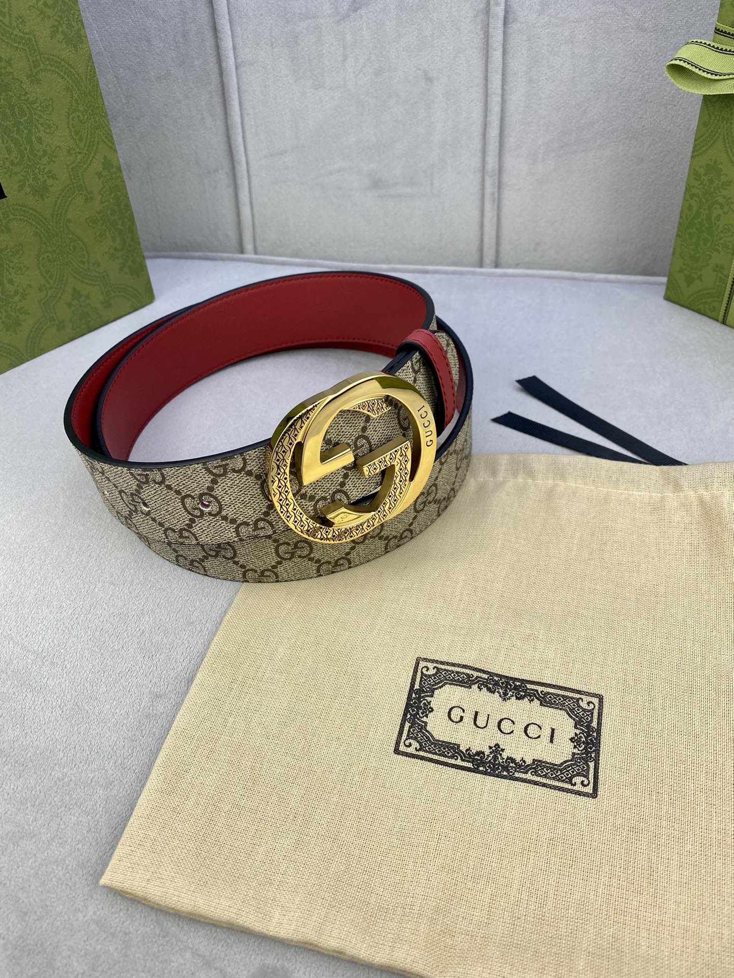 Gucci belt looped view, beige GG canvas with red lining and gold double-G buckle
