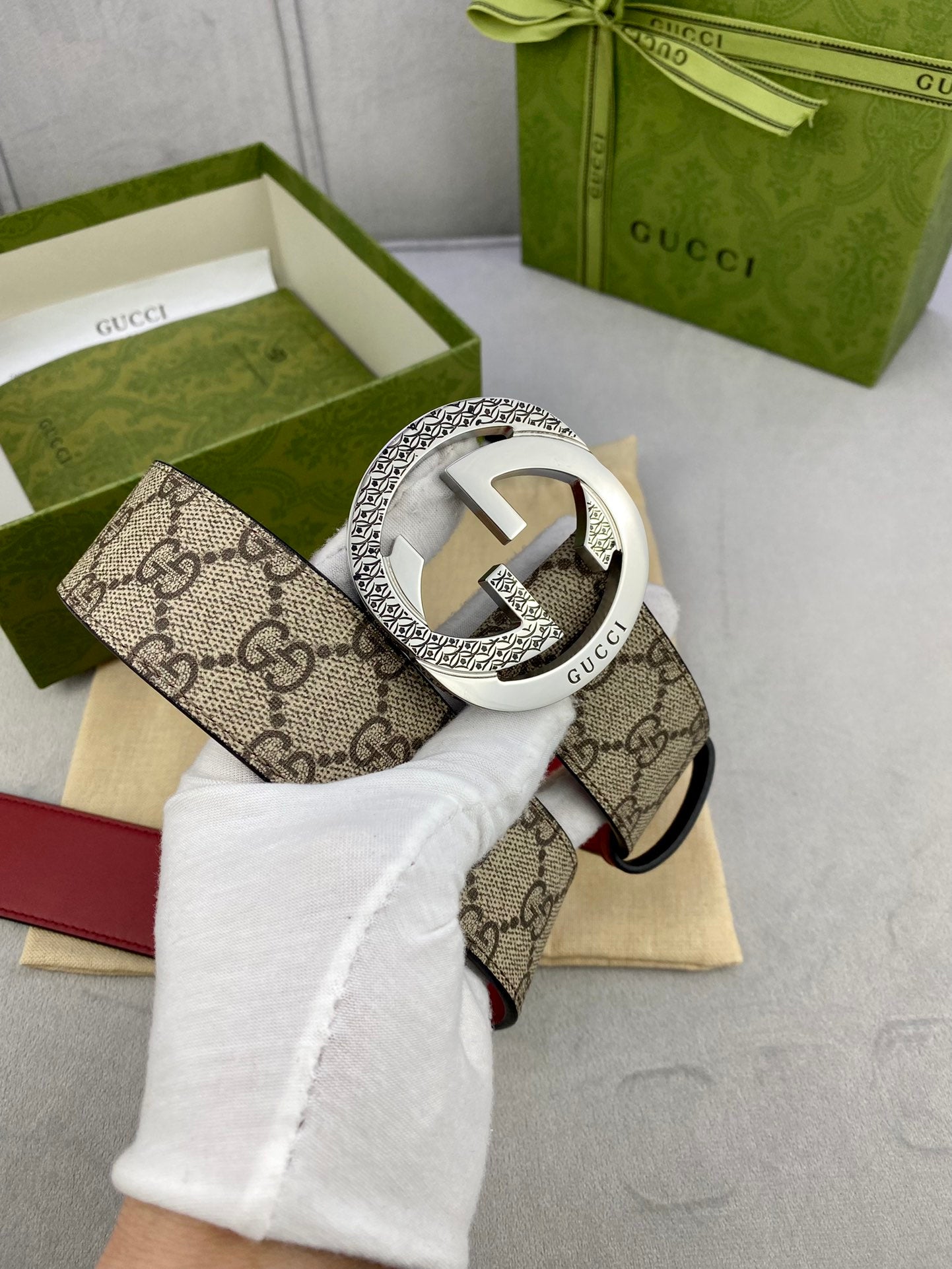 Gucci belt with silver G buckle detail on beige GG canvas and red strap