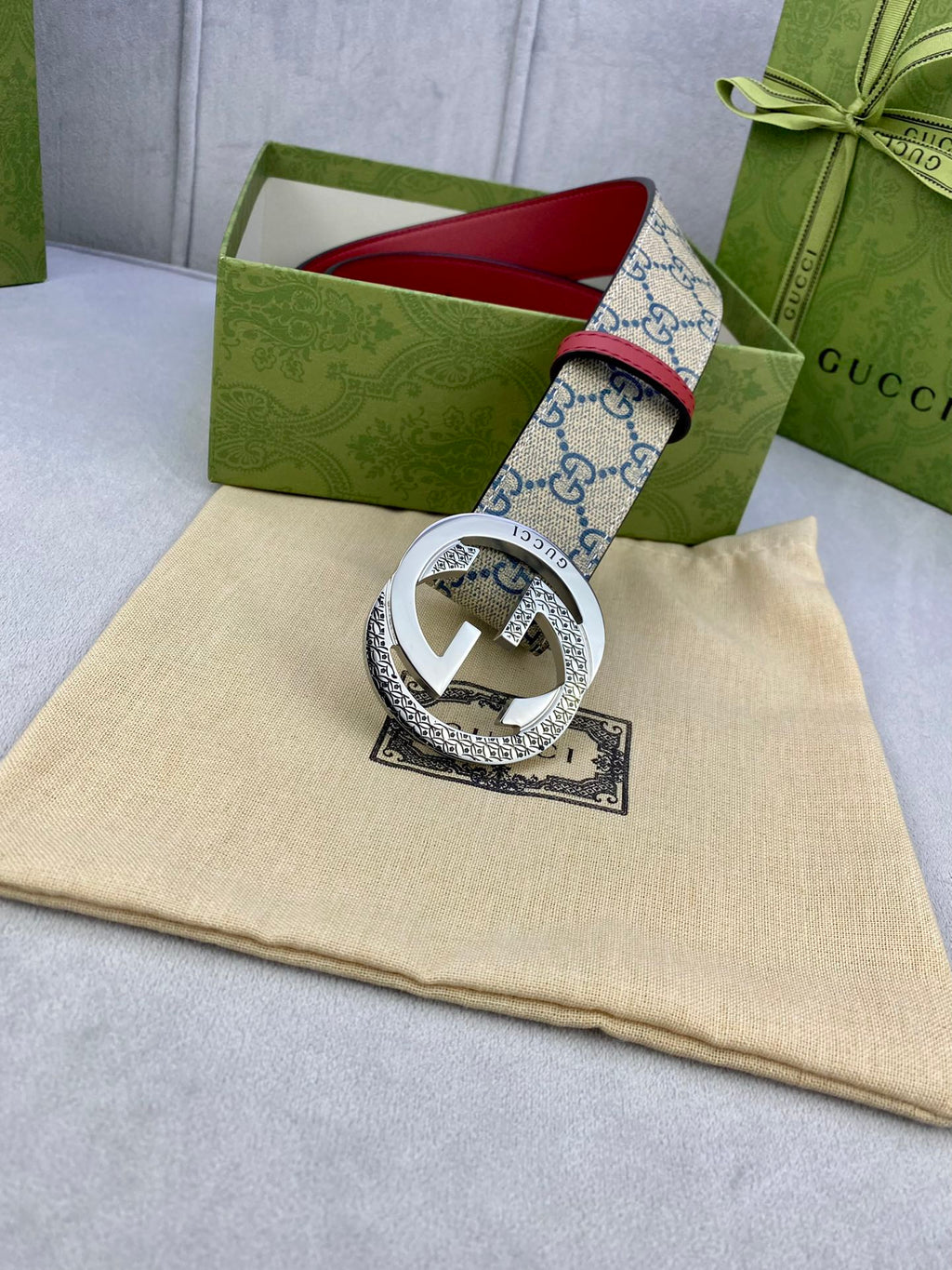 Logo-print belt with red leather edge, silver round buckle, and leather strap