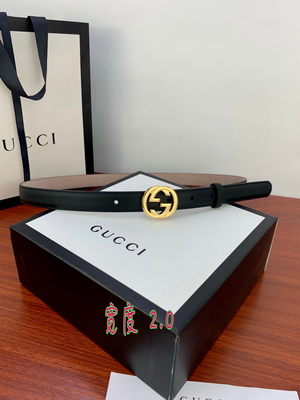 Gucci belt in dark leather with gold interlocking G buckle and metal pin holes