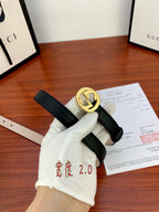 Gucci belt with dark leather strap and gold interlocking G buckle, shown flat