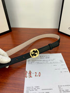 Gucci belt with dark leather strap and gold interlocking G buckle, side view