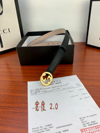 Gucci belt with dark leather strap, gold interlocking G buckle, product tag visible