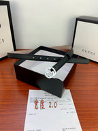 Gucci belt with dark leather strap and silver-toned interlocking G buckle on box
