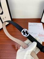 Gucci belt with dark leather strap and silver interlocking G buckle, front view