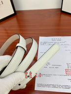White leather belt strap with buckle attachment holes and smooth finish.