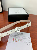 White leather Gucci belt with silver double-G buckle and stitched strap edges.