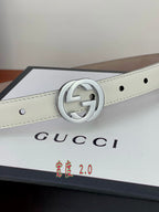 White leather belt with silver double-G buckle centered on the strap.