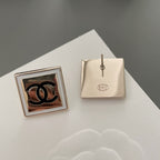 Chanel stud earrings pair showing one front and one back with fastening post