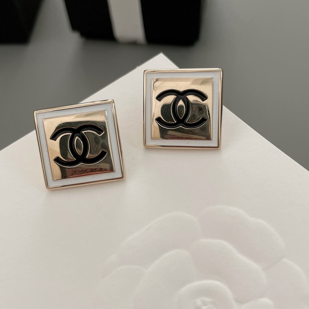 Chanel stud earrings with square settings and black CC logo, front view pair