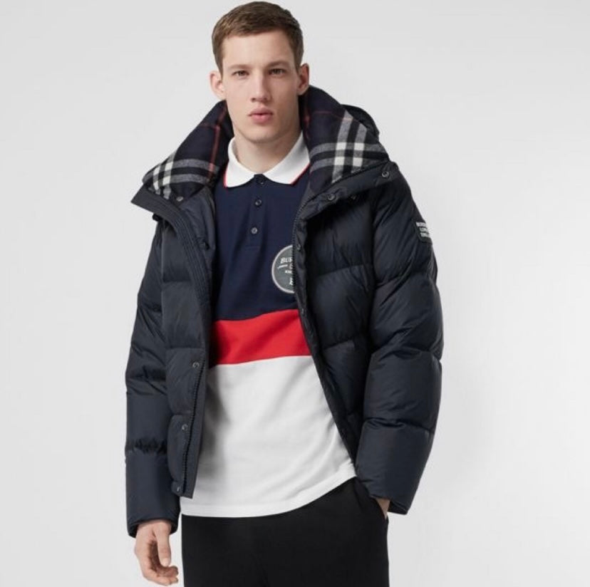 Burberry long hooded puffer jacket in dark navy with plaid-lined collar and zipper