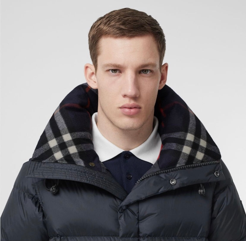 Burberry long hooded puffer jacket close-up with plaid hood lining and dark quilted fabric