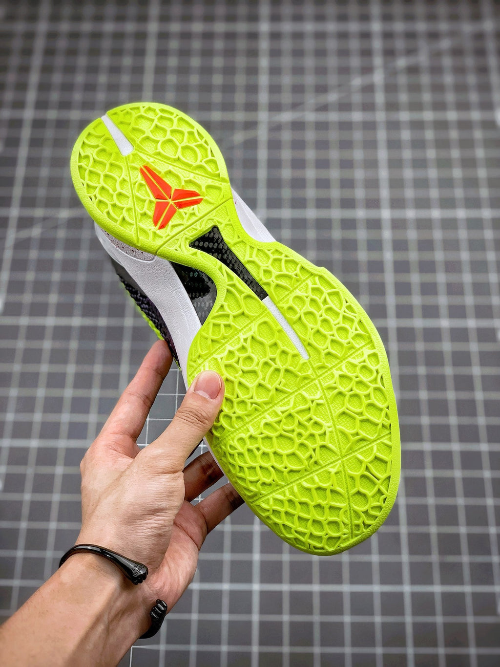 Navy basketball sneaker outsole with neon green traction pattern