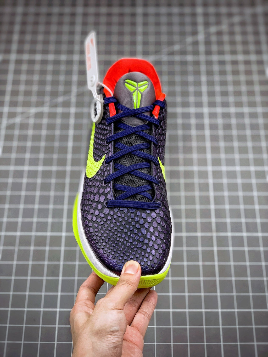 Navy basketball sneaker with blue laces, neon green swoosh, red collar, front view