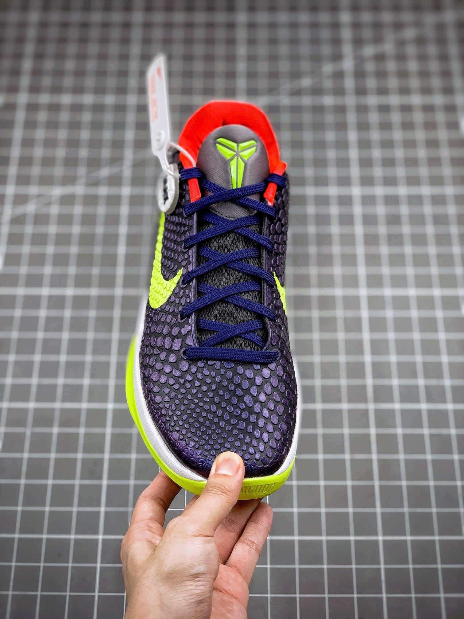 Navy basketball sneaker with blue laces, neon green swoosh, red collar, front view