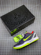 Pair of navy basketball sneakers with neon green accents and laces beside black box